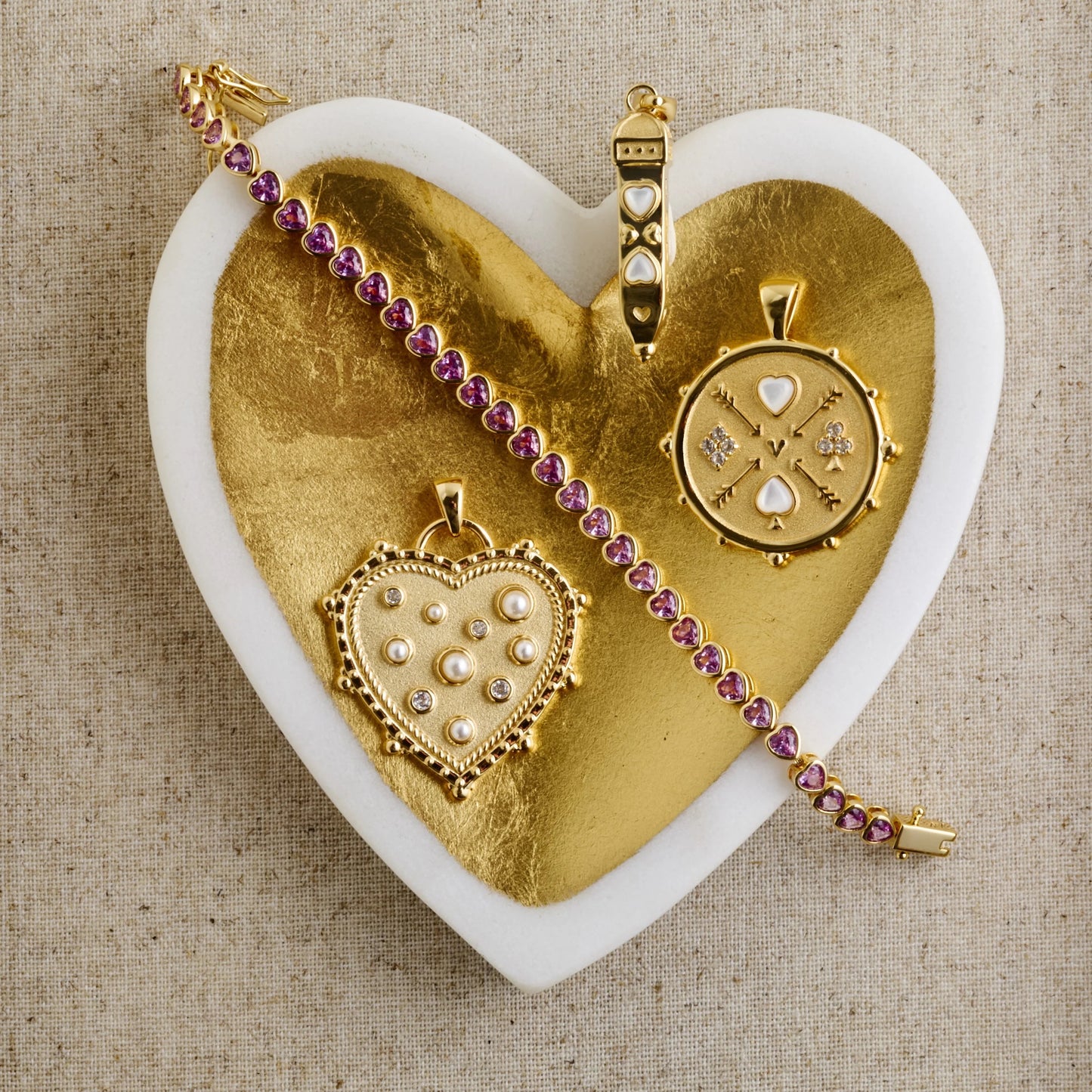 Gold jewelry set with pendants on a heart-shaped gold base