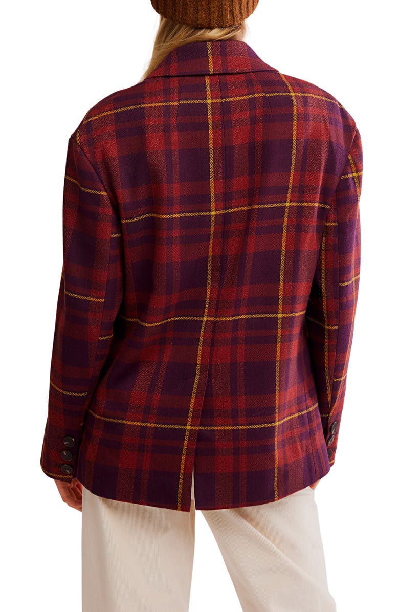 Red and blue plaid jacket worn by a person on a white background