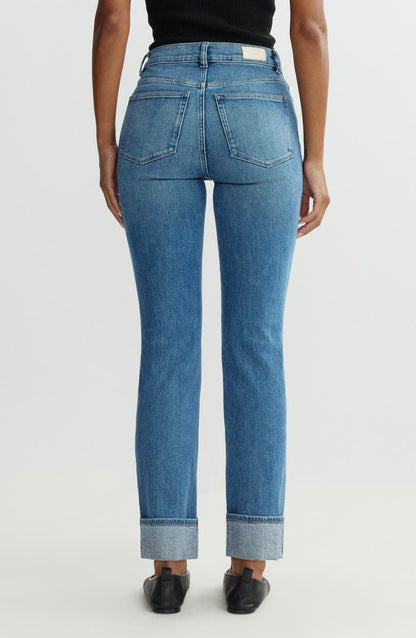 Blue jeans worn by a person on a white background