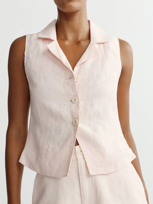 Light pink linen vest and shorts set on a plain background