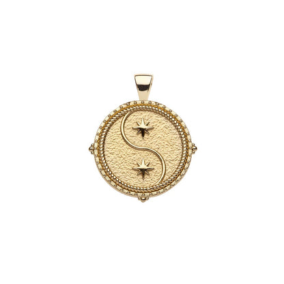 Gold pendant with star design on a white background