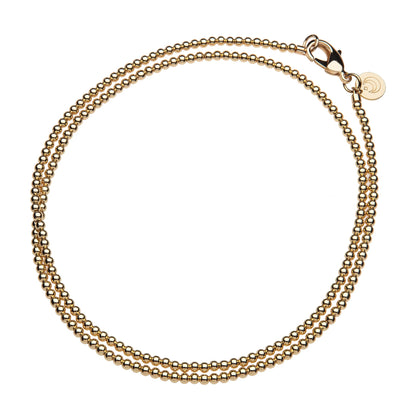 Gold chain bracelet on a white background