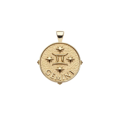 Gold pendant with 'GEMINI' inscription on a white background