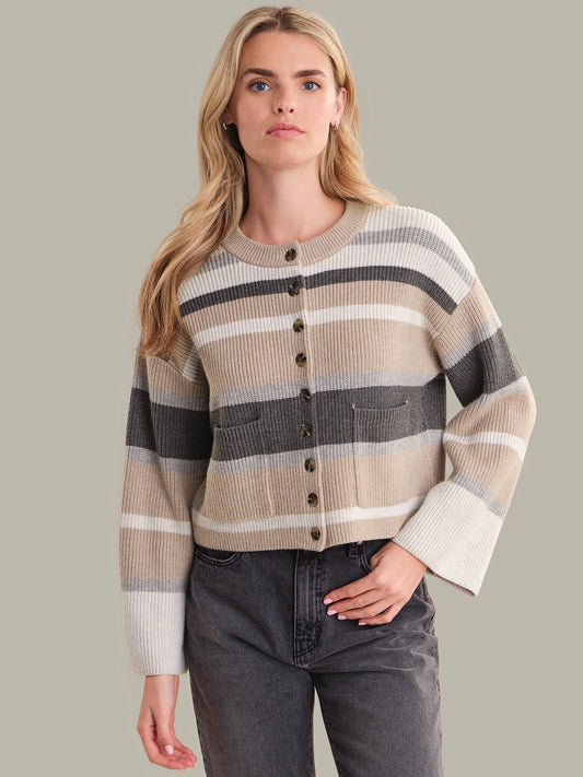 Woman wearing a striped sweater with a plain background