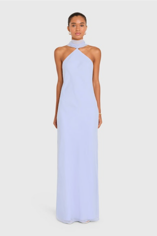 Woman wearing a light blue halter neck gown on a white background