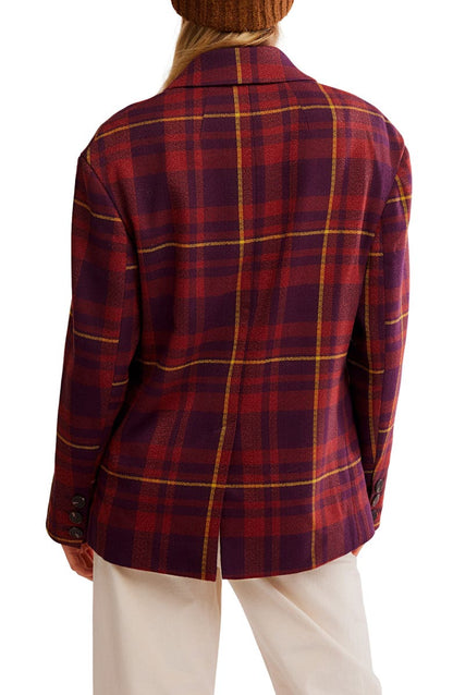 Red and blue plaid jacket worn by a person on a white background