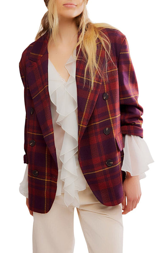 Plaid jacket over a white blouse with ruffles on a white background