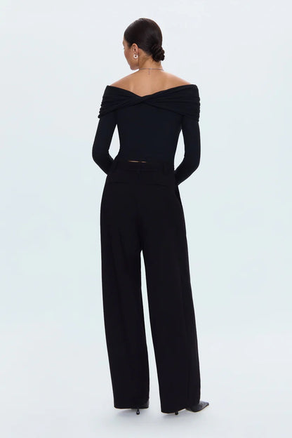 Black off-shoulder jumpsuit worn by a model on a white background