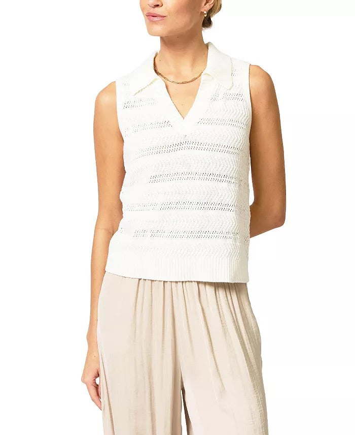 Woman wearing a white sleeveless top and beige pants on a white background