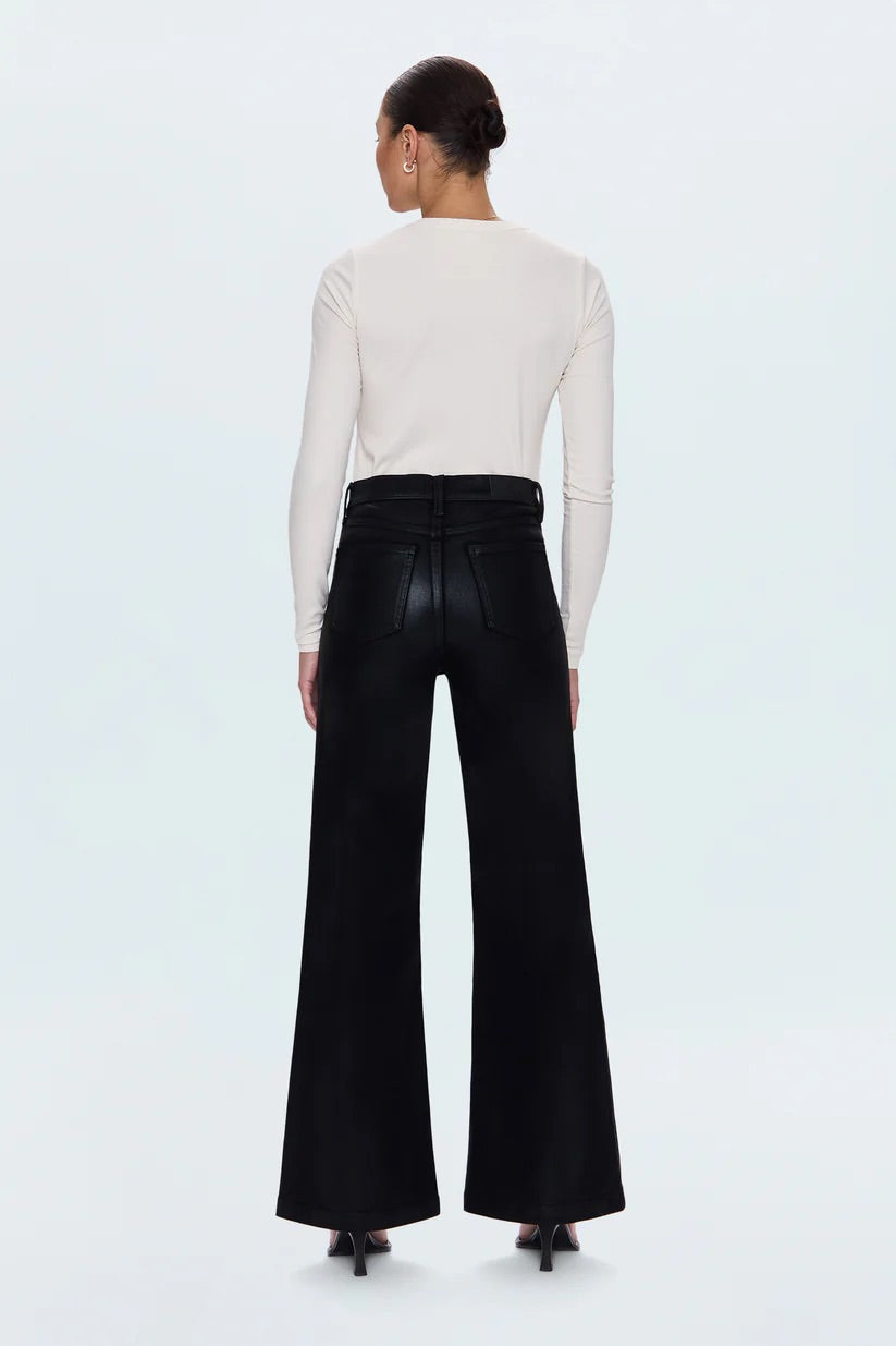 WOMEN IN BLACK LEATHER PANTS ON A WHITE BACKGROUND