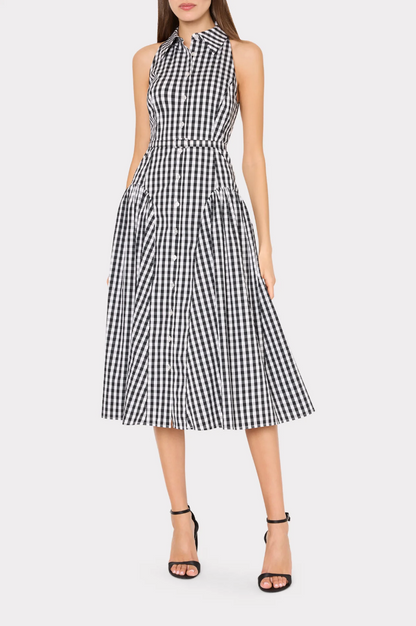 Woman wearing a black and white checkered dress on a white background