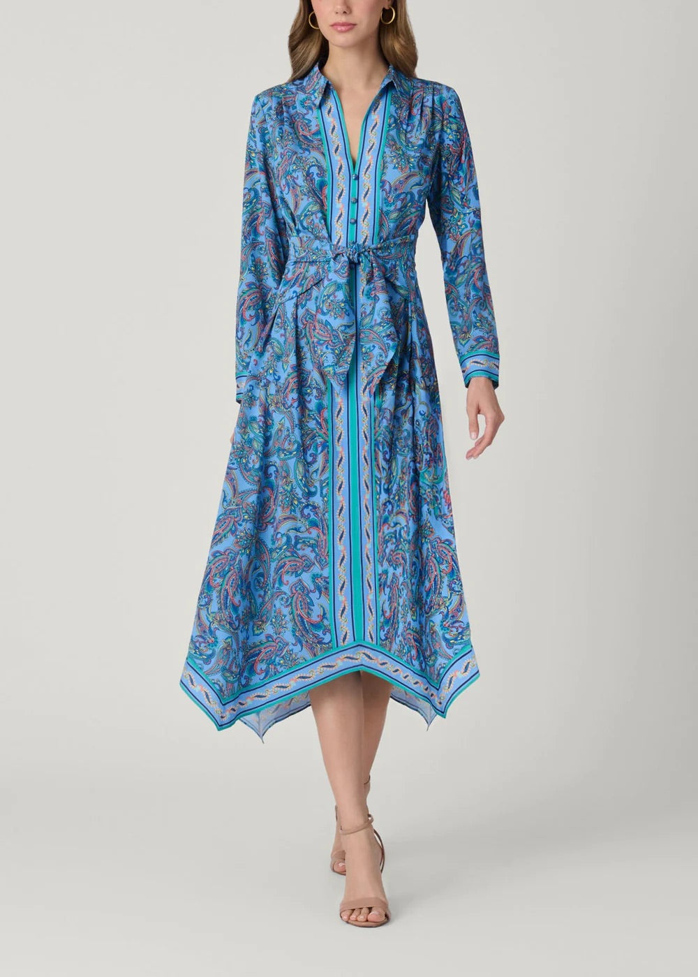 Woman wearing a blue patterned dress on a gray background