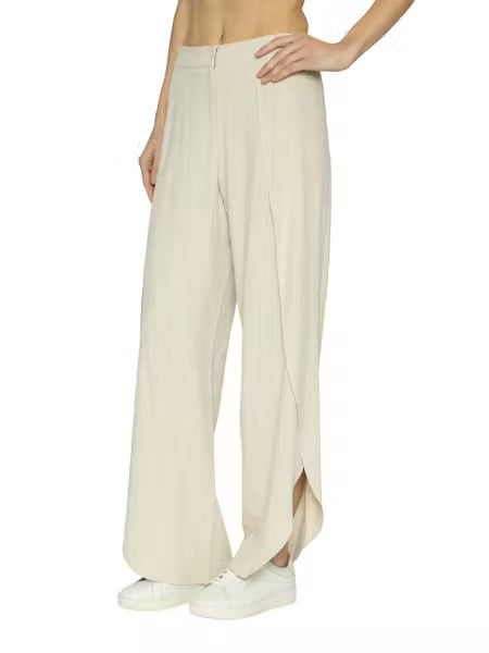 Beige wide-leg pants worn by a person on a white background