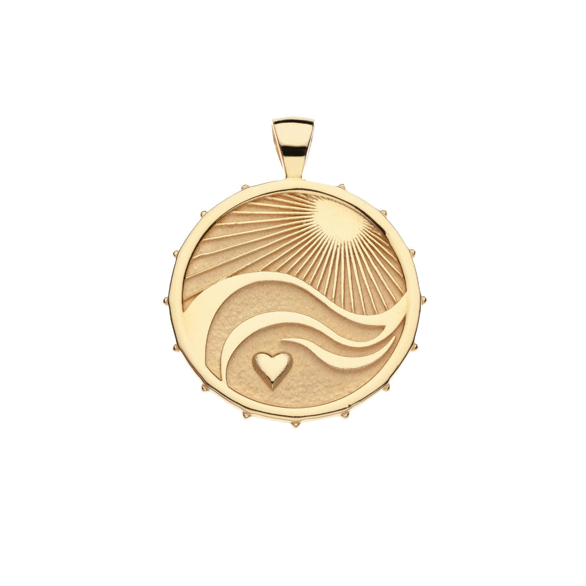 A round gold pendant featuring an engraved sunburst, flowing wave lines, and a small heart, shown on a plain white background.