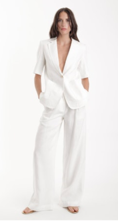 Woman wearing a white suit on a white background