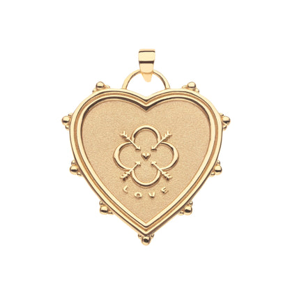 Gold heart-shaped pendant with intricate design on a white background