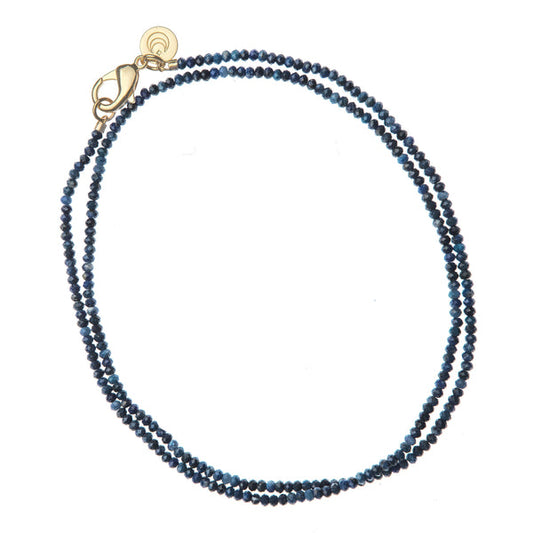 Blue beaded necklace with a gold clasp on a white background