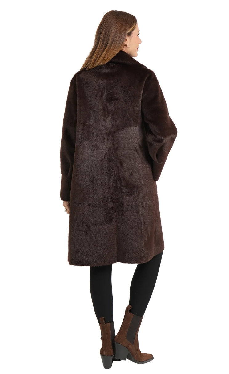 Woman wearing a brown fur coat on a white background