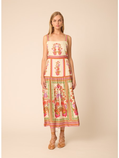 Woman wearing a floral dress on a beige background