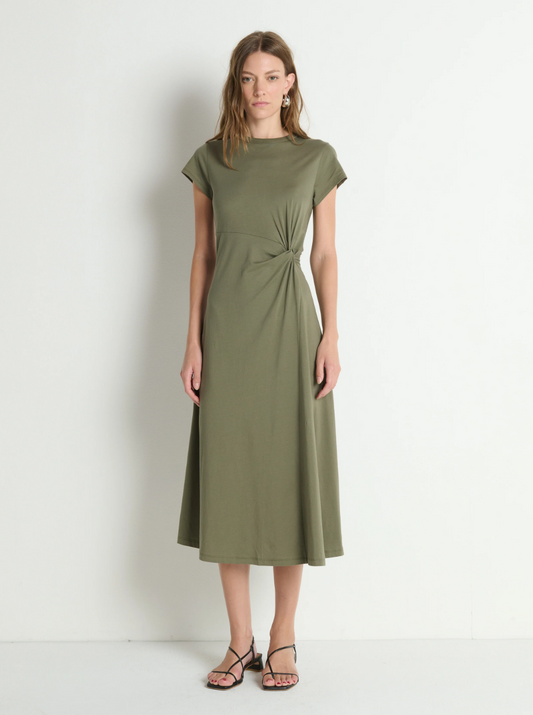 Woman wearing a green dress against a white background