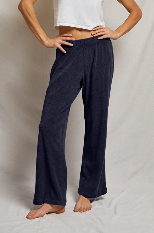 Person wearing the perfectwhitetee terry lounge navy blue pants and a white top on a plain background