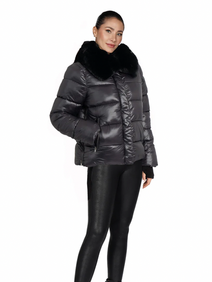Woman wearing a black puffer jacket with fur trim on a white background