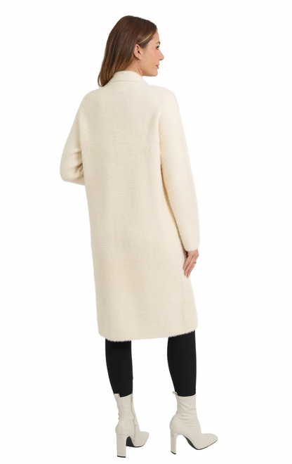 Woman wearing a long cream coat on a white background