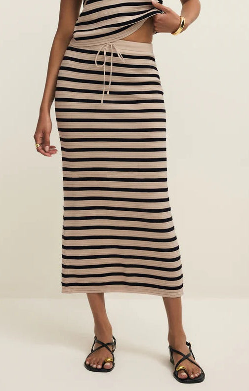 Woman wearing a black and white striped dress on a white background