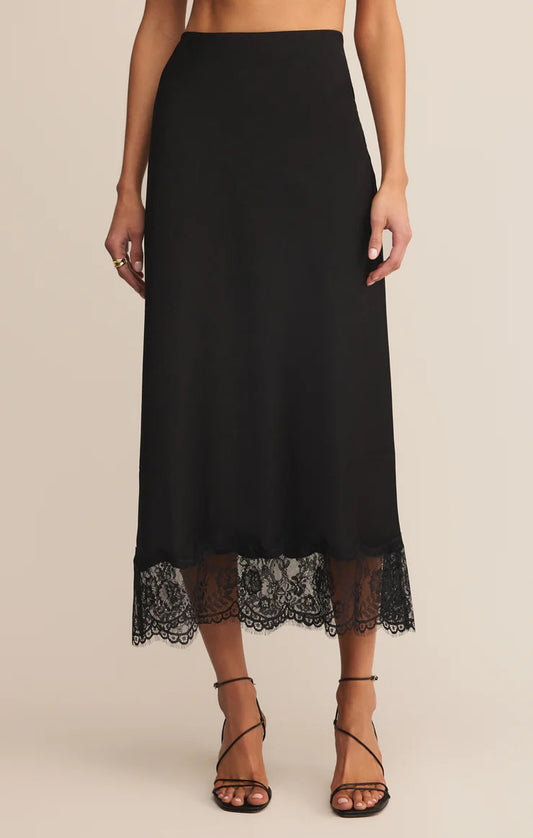 Black skirt with lace hem on a beige background